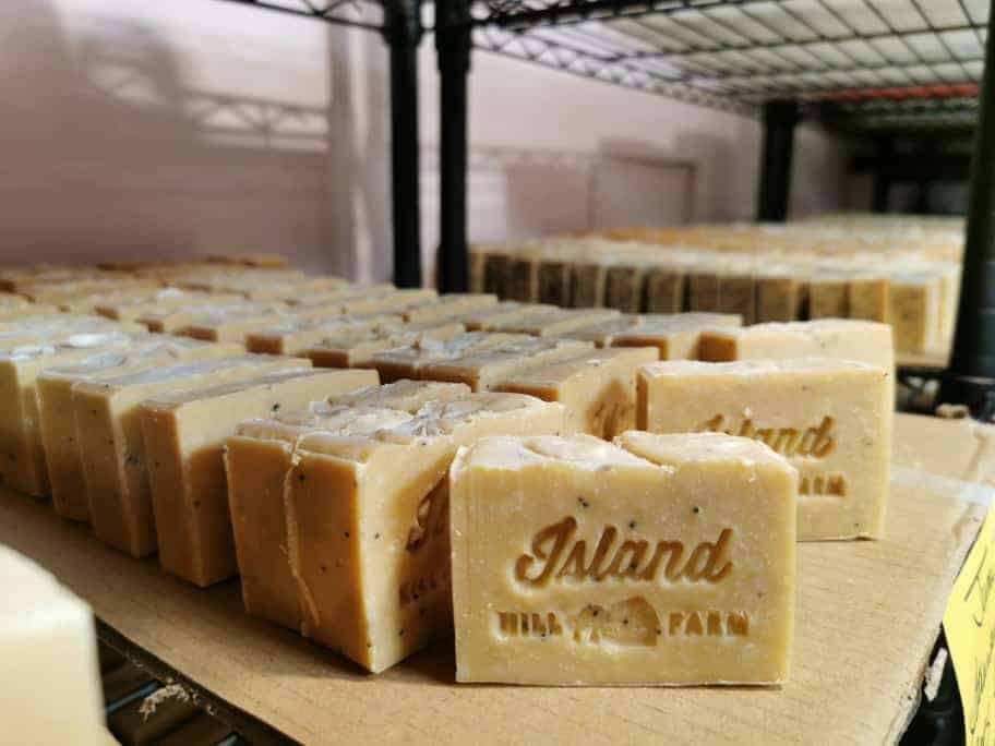 goats milk soap bars on a shelf stamped with the island hill farm logo