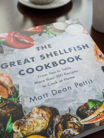 A copy of the great shellfish cookbook on a table