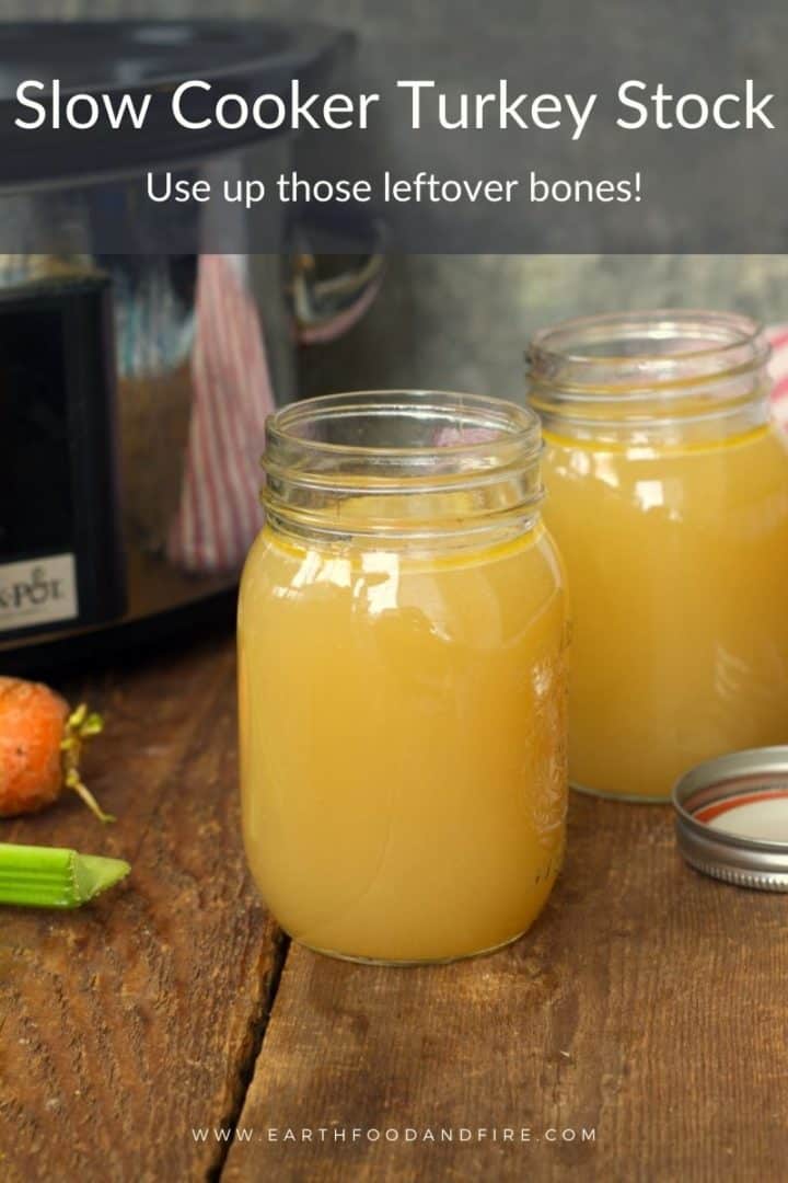 2 mason jars filled with slow cooker turkey stock on a wooden background