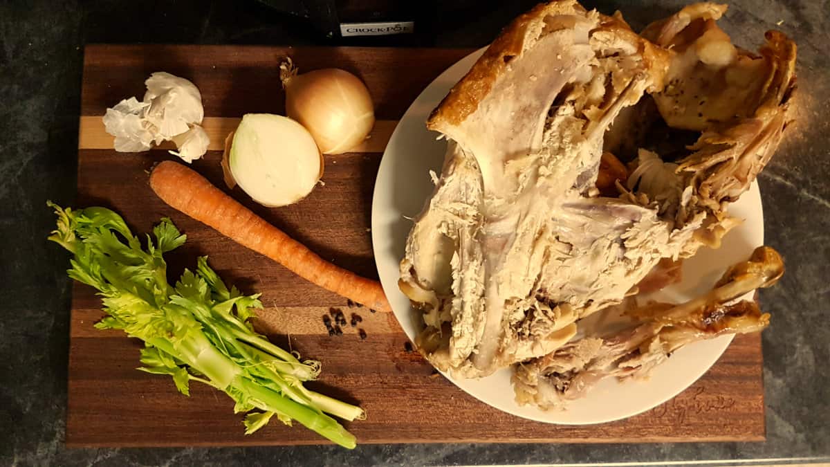 turkey stock ingredients on a wood block cutting board