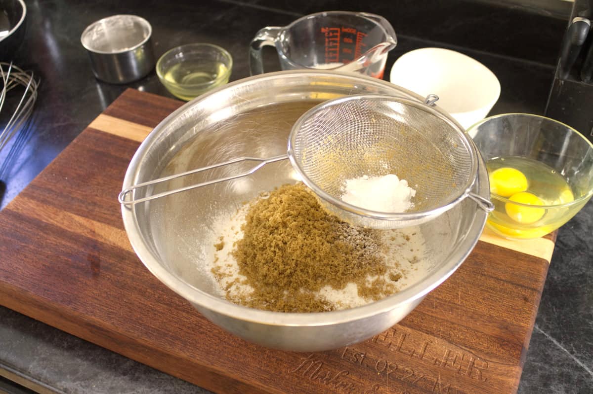 sifting the dry cornbread ingredients