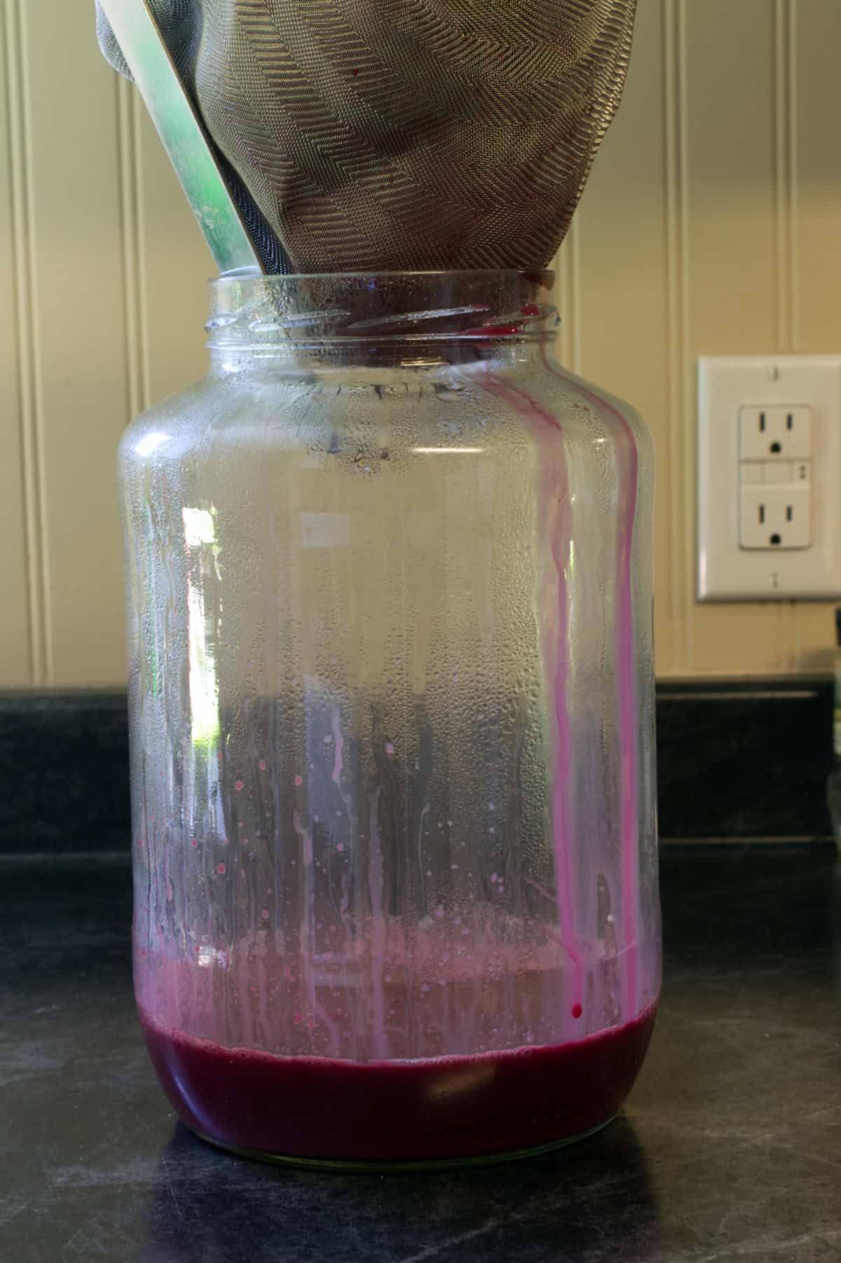 chokecherry juice being strained