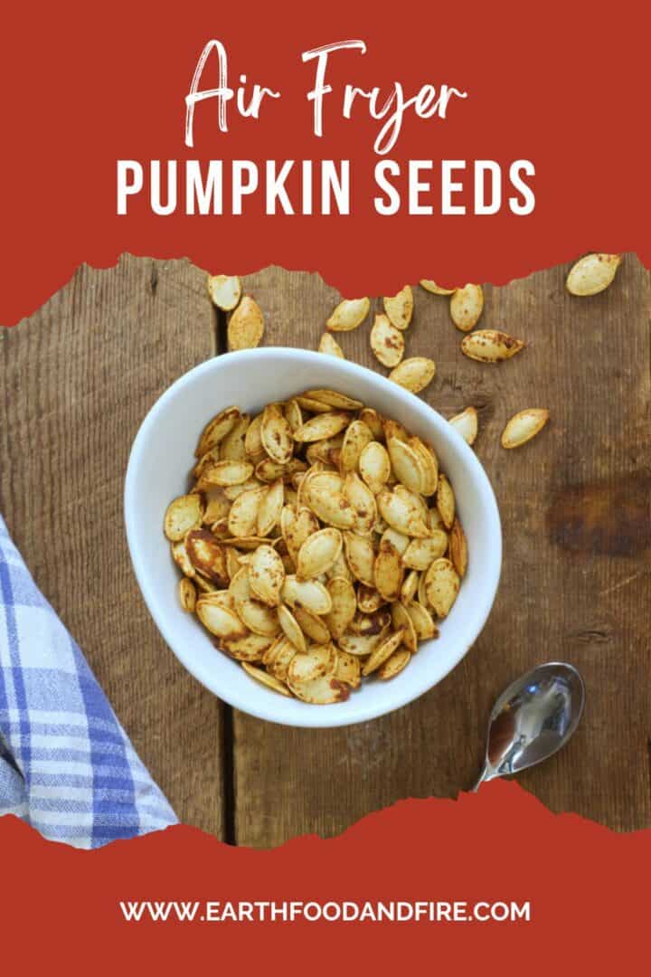 A pinterest pin image of air fryer roasted pumpkin seeds in a white porcelain bowl.