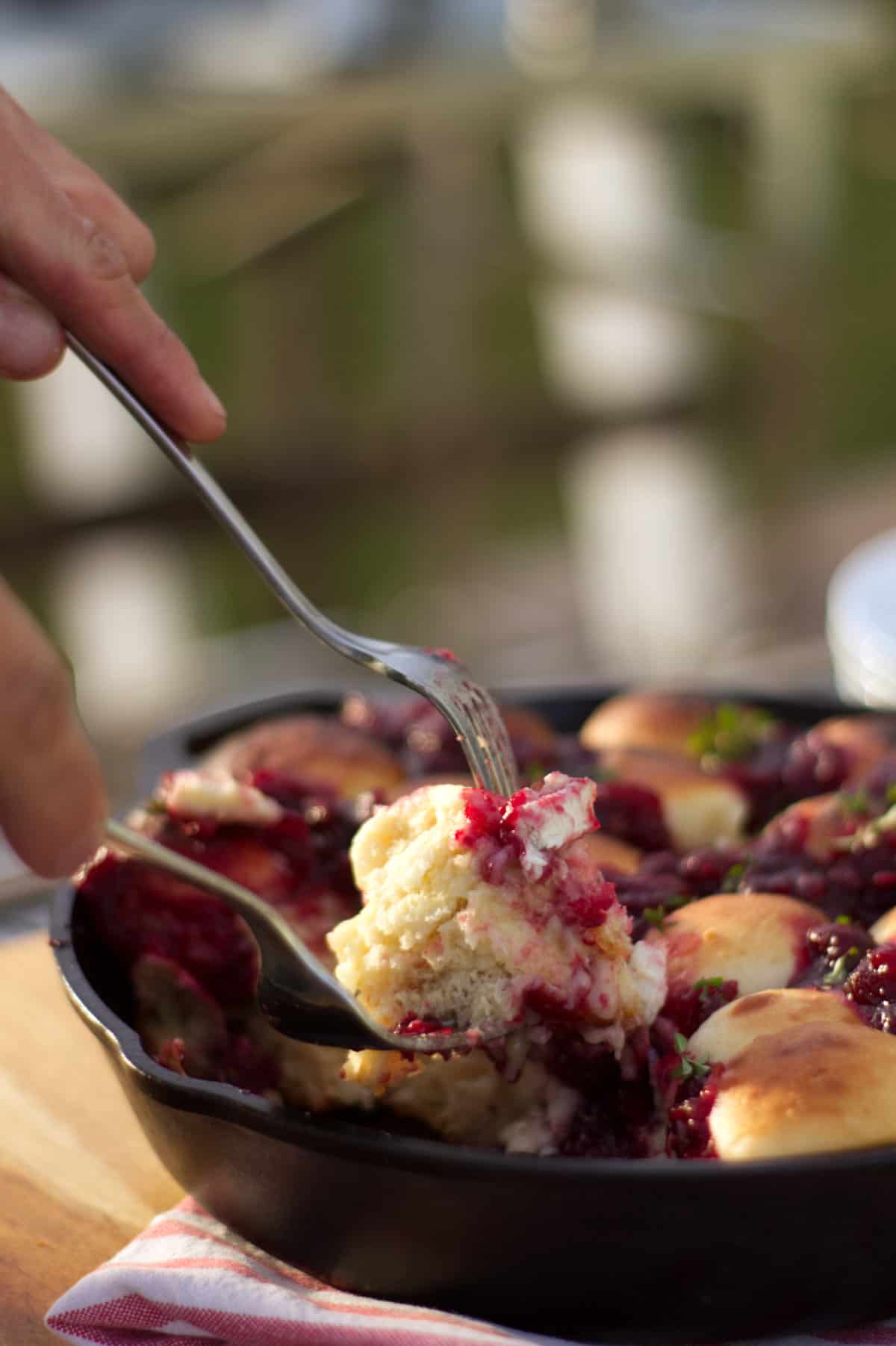 Close-up vertical image of the cranberry pull apart bread being served.
