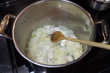 Sauteeing onions and garlic in a large soup pot.