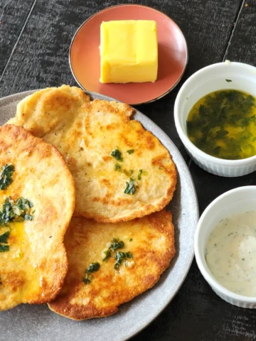Homemade Naan Without Yeast with butter, garlic and coriander topping with Tzaziki dip on the side