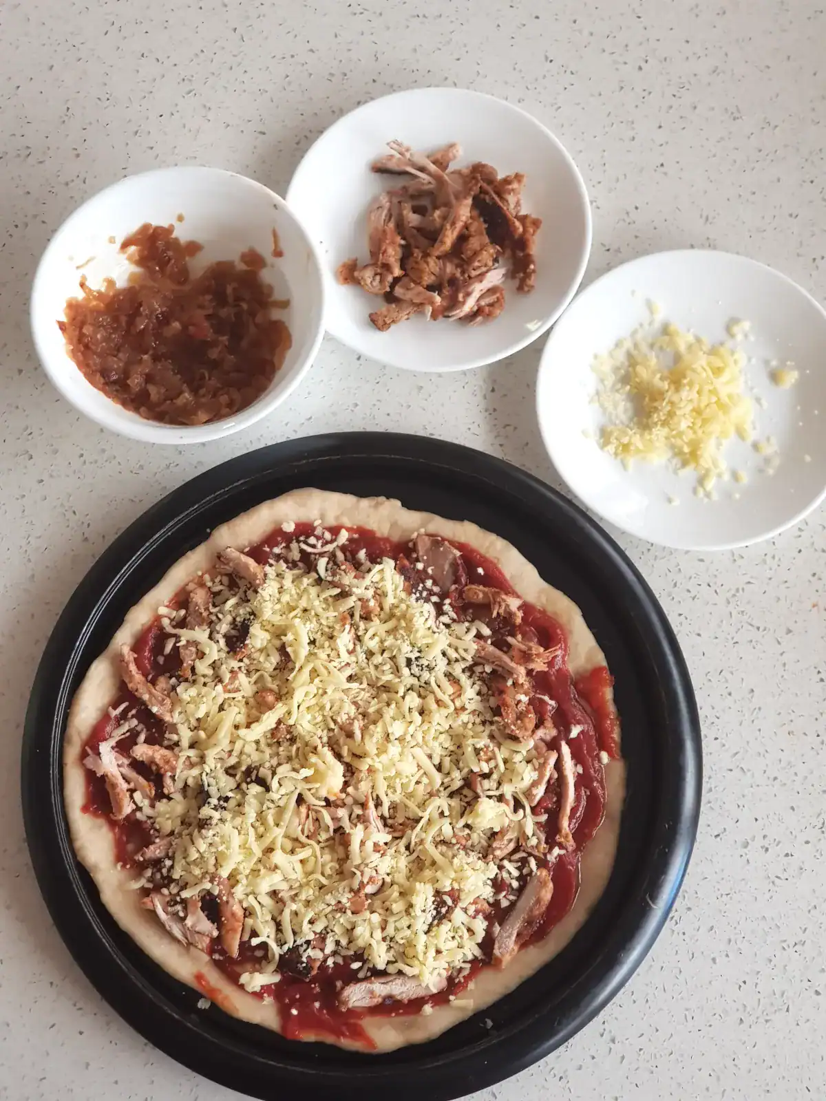 Homemade pizza dough base with toppings