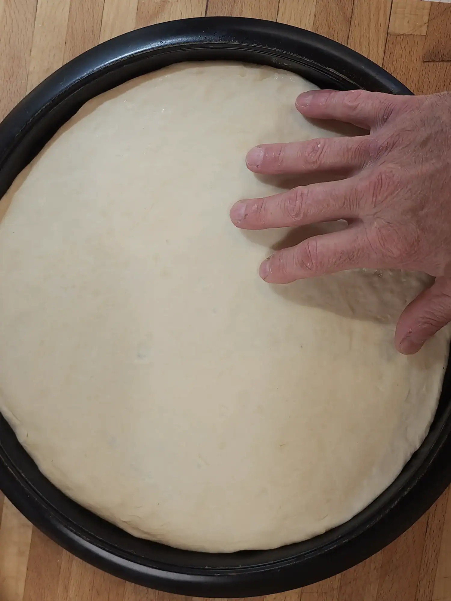Homemade pizza dough on pizza tray