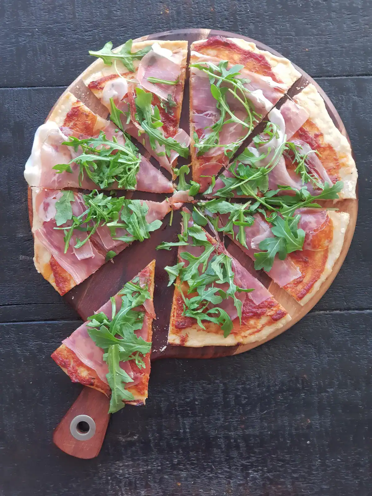 Homemade pizza with prosciutto and rocket