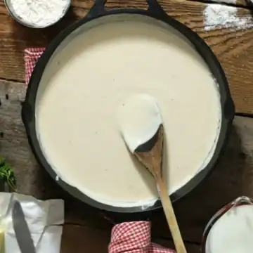 Thickened Bechamel sauce in a cast iron pan