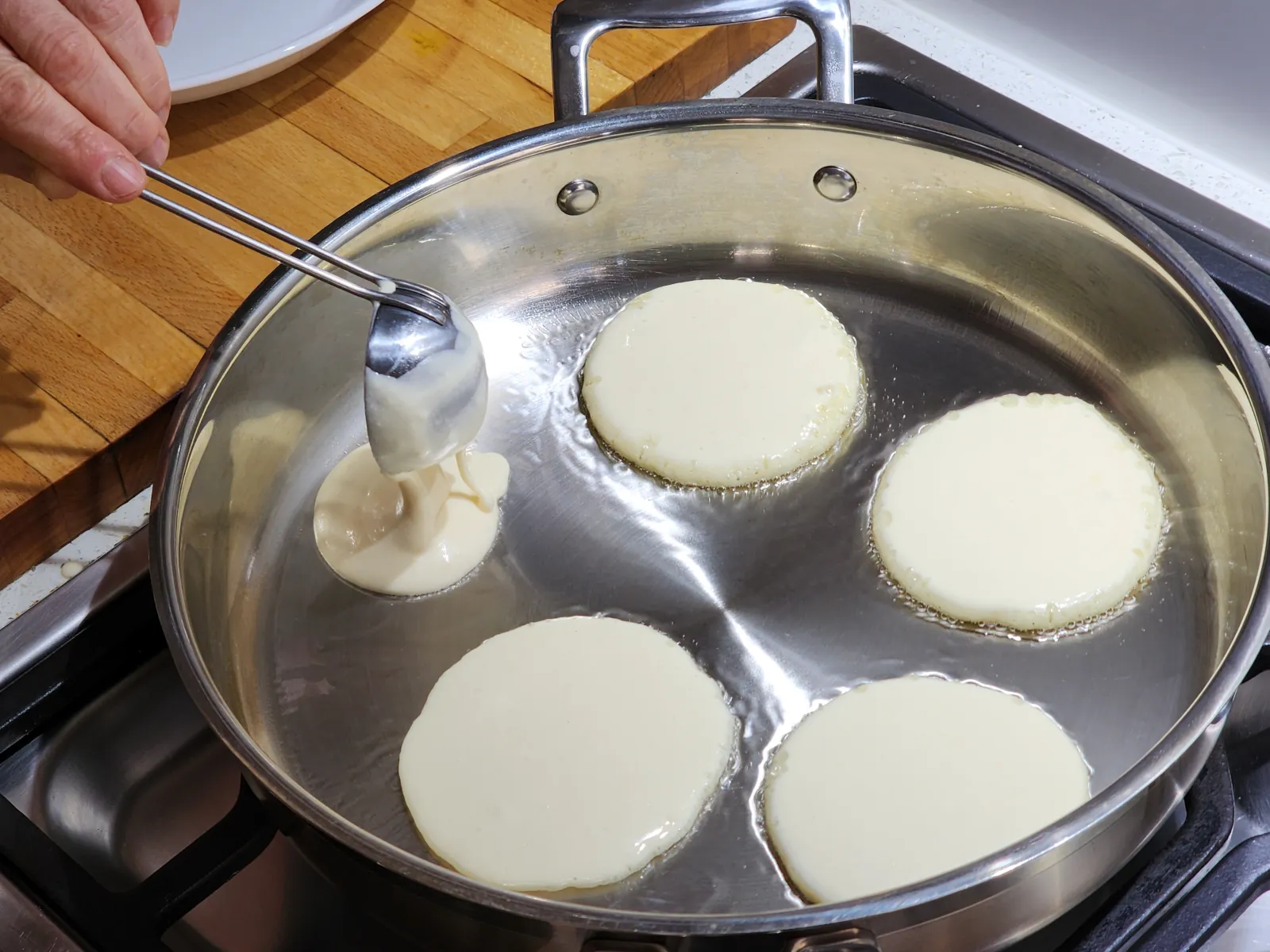 Frying mini pancakes - first side