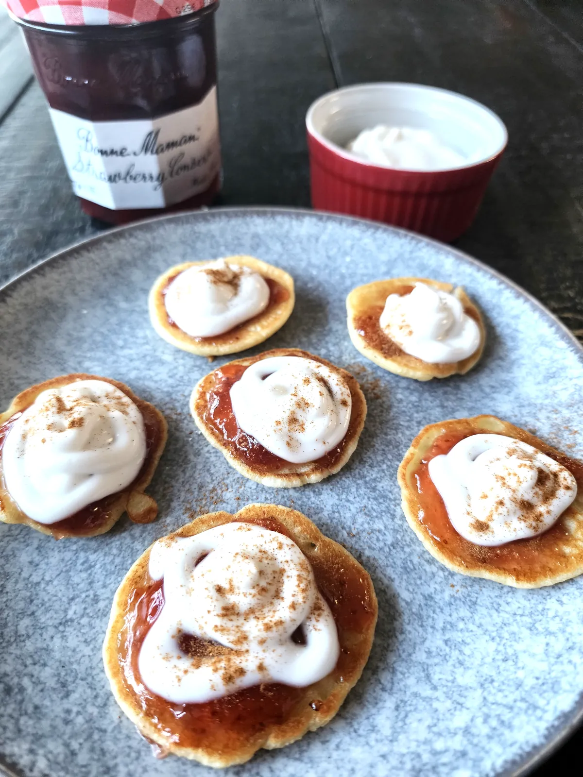 Mini pancakes with strawberry preserves, yogurt, sprinkled with cinnamon