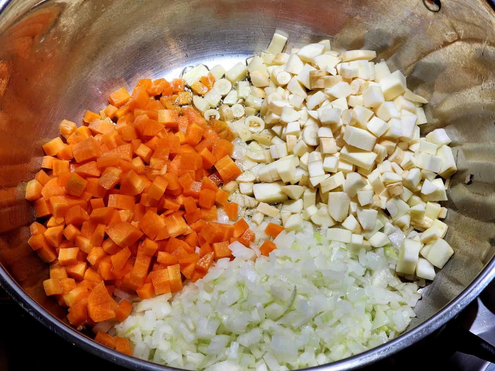 Sautéing onions, carrots, and parsnip for gluten-free homemade potato soup