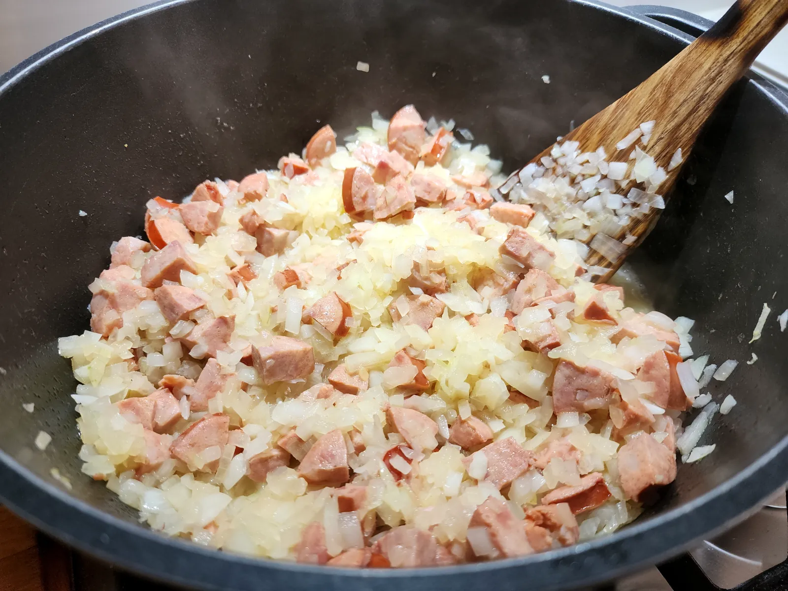 Frying onion and sausage for the potato goulash