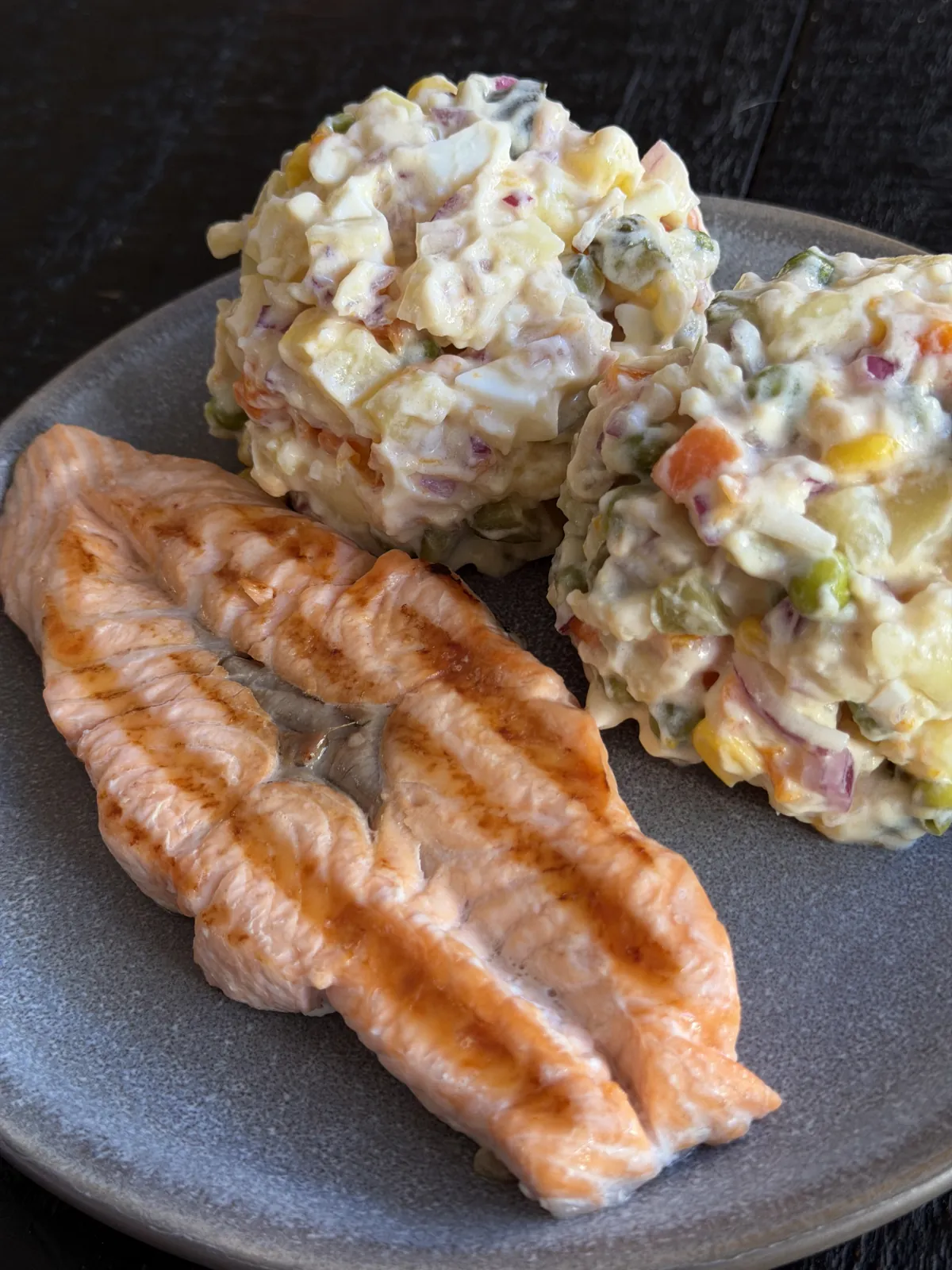 Grilled salmon served with potato salad