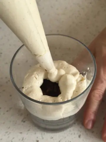 Second layer: adding cream filling into the glass with piping bag