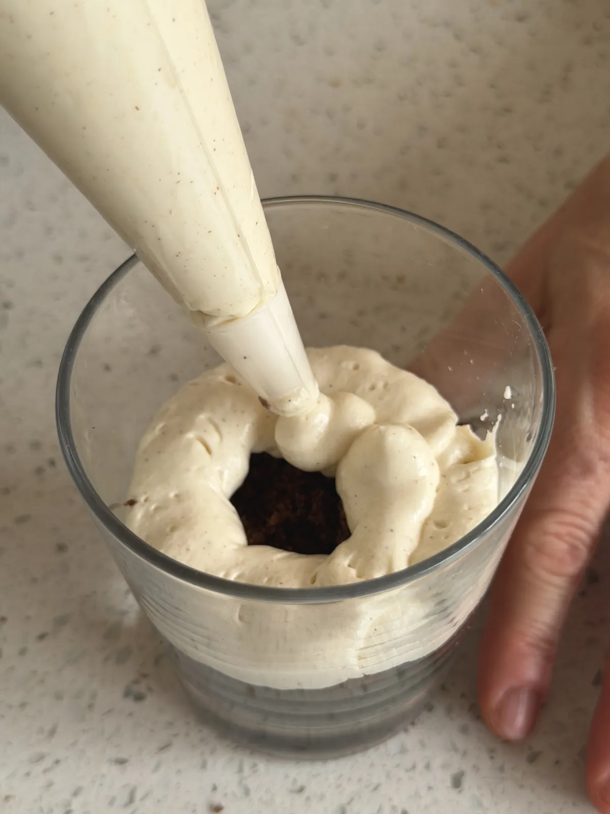 Second layer: adding cream filling into the glass with piping bag
