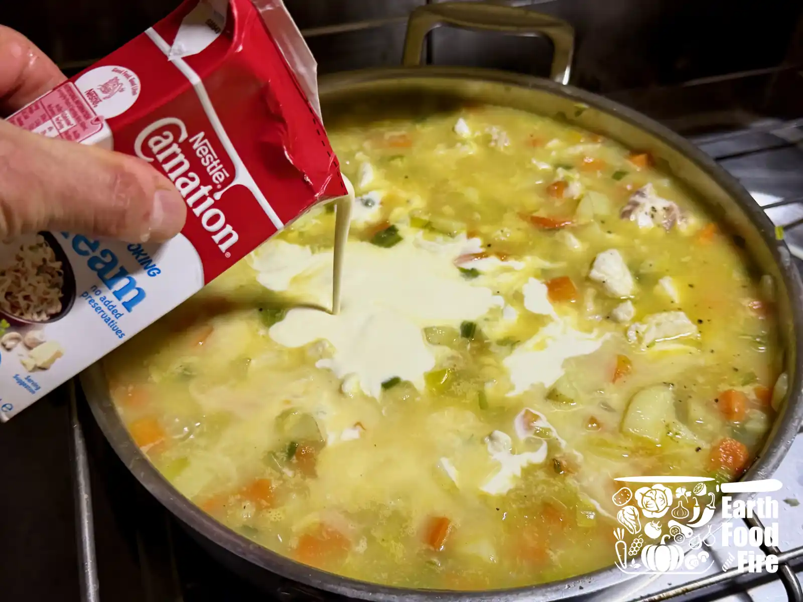 Cream being stirred into the finished chowder.