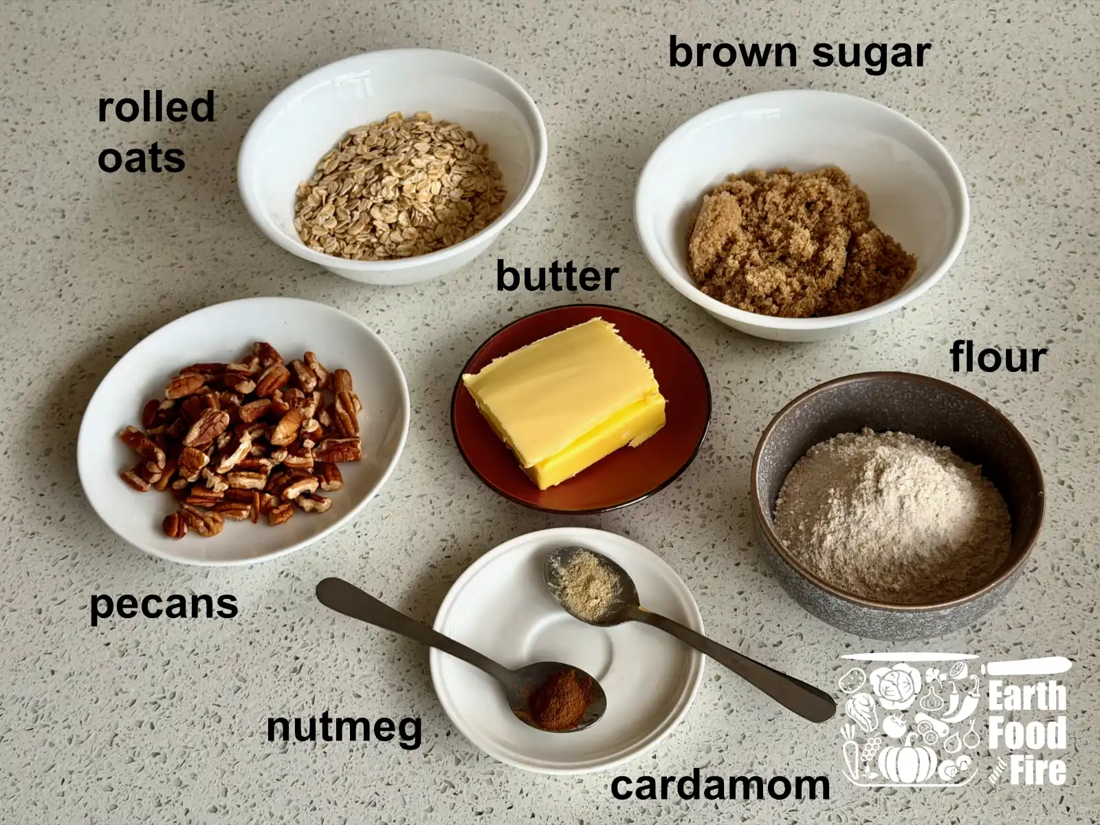 Applesauce crisp topping ingredients - rolled oats, brown sugar, butter, pecans, all-purpose flour and spices - cardamom and nutmeg.