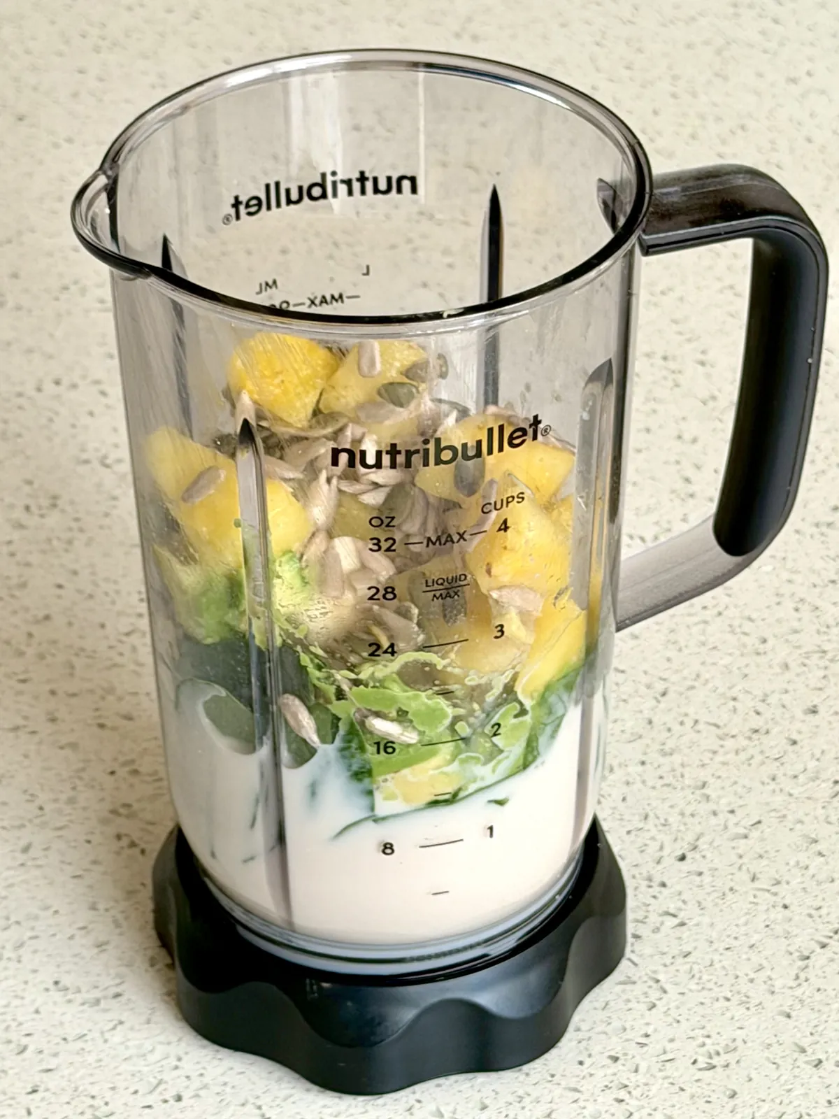 Avocado smoothie ingredients in the blender before blending