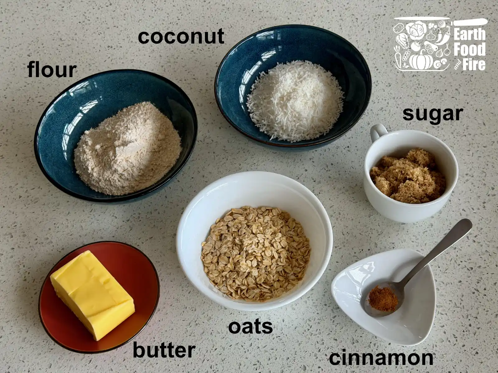 Ingredients for the blueberry crumble recipe crumble topping laid out on table - flour, coconut, sugar, butter, oats and cinnamon