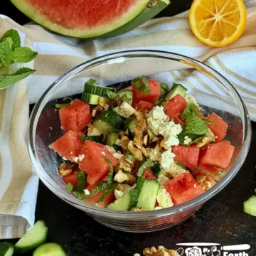 Feta cheese and watermelon salad recipe served in a glass bowl with fresh mint and toasted walnuts