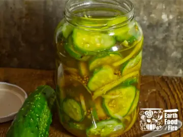 A freshly packed fridge pickled cucumbers in a jar, brine poured to the top.