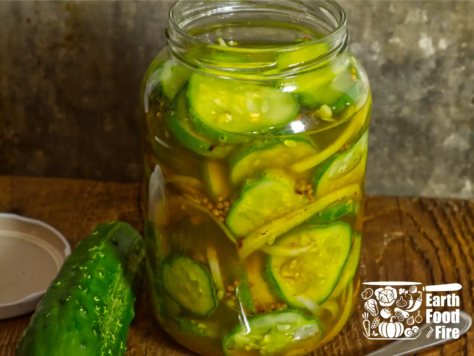 A freshly packed fridge pickled cucumbers in a jar, brine poured to the top.