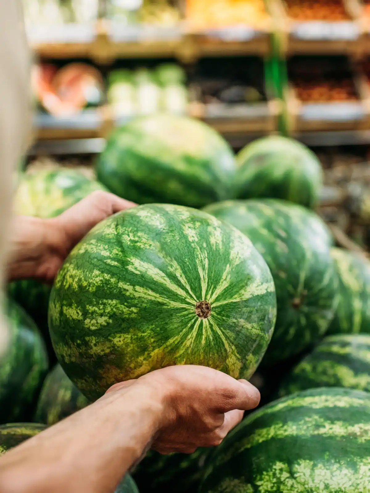 How to pick the best watermelon - choosing a melon from a pile in the produce aisle