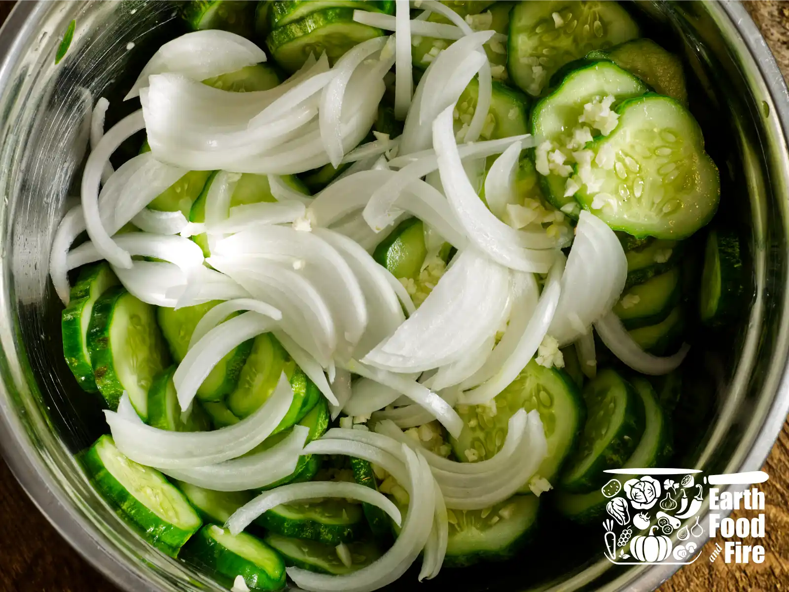 Onion and garlic folded into the drained, salted cucumbers.
