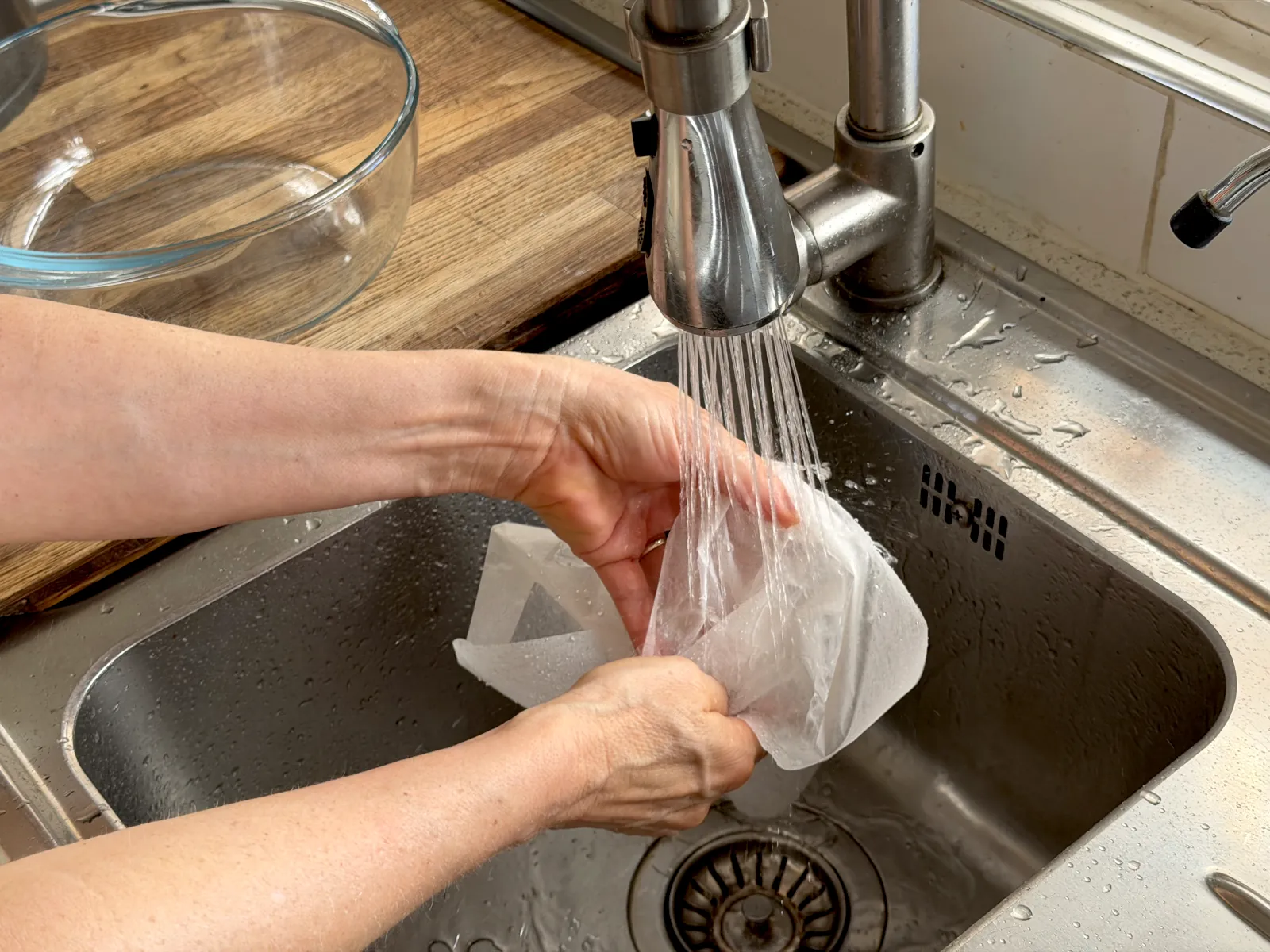 Holding parchment/baking paper under the tap water until it's soaked