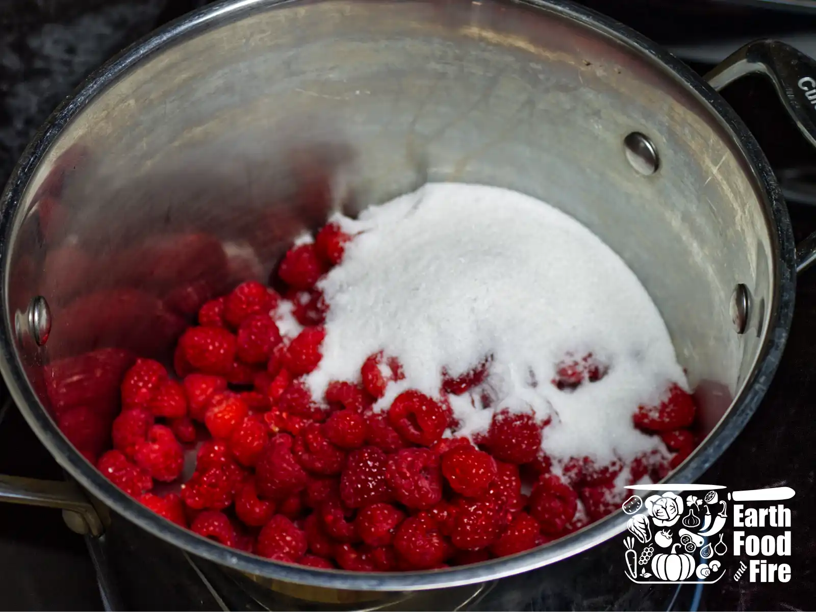 Raspberries and sugar in the stainless steel pot, ready for cooking