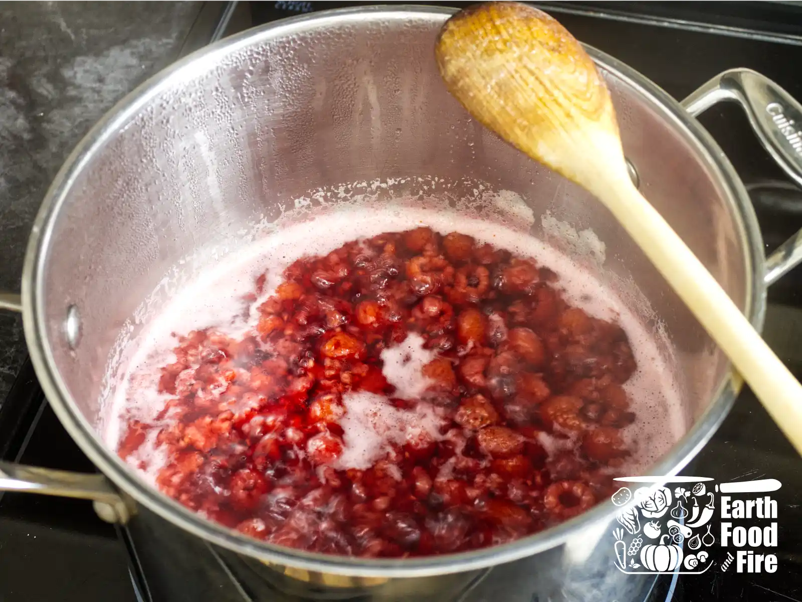 Raspberry cordial ingredients simmering in a pot on stove