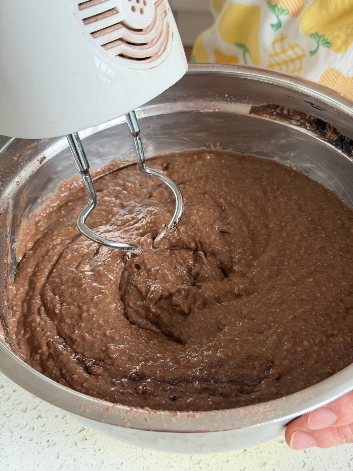 Combined ingredients for chocolate cake with a hand mixer using easy recipes for cakes