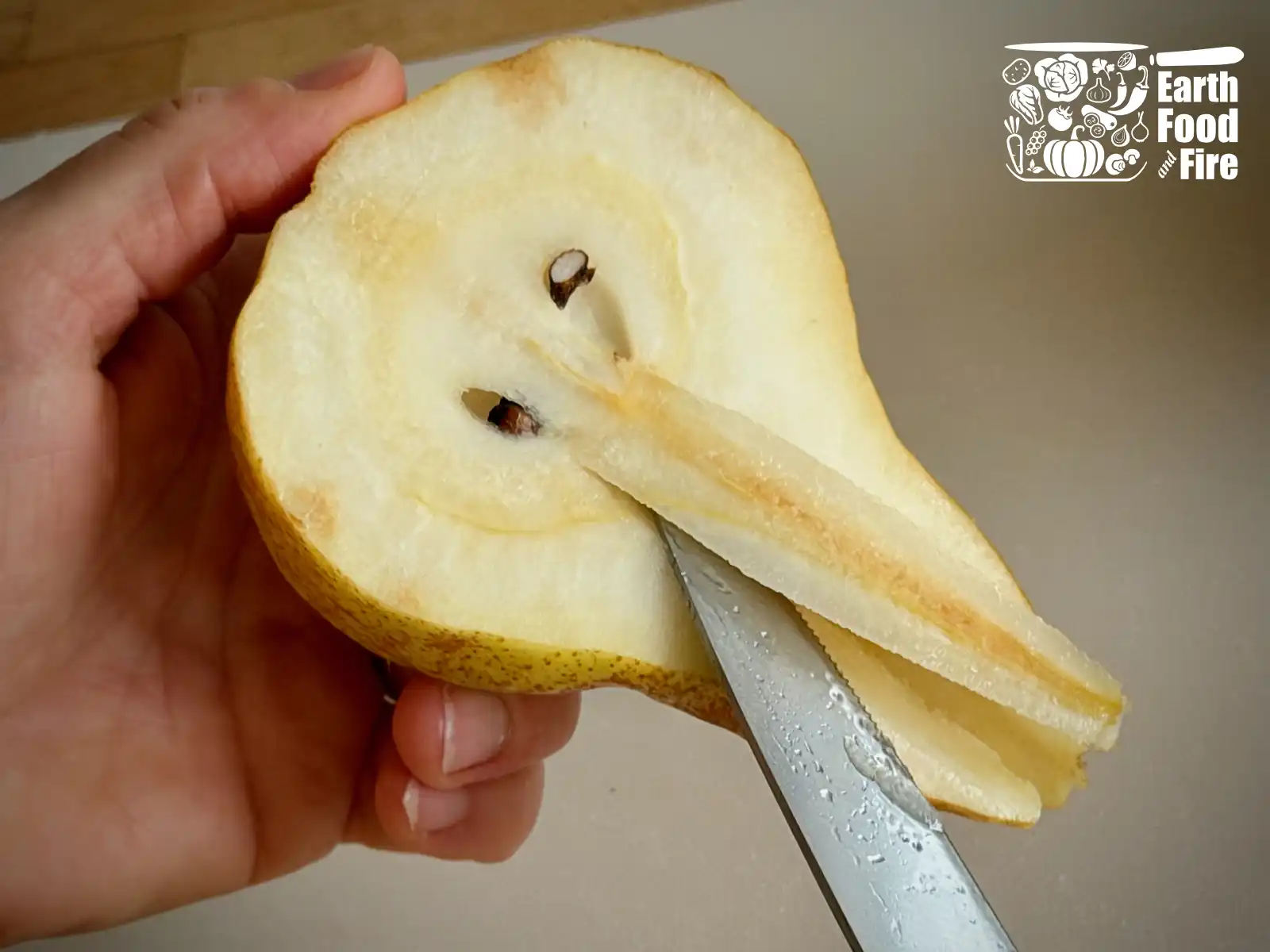 Removing fibrous core from the pear