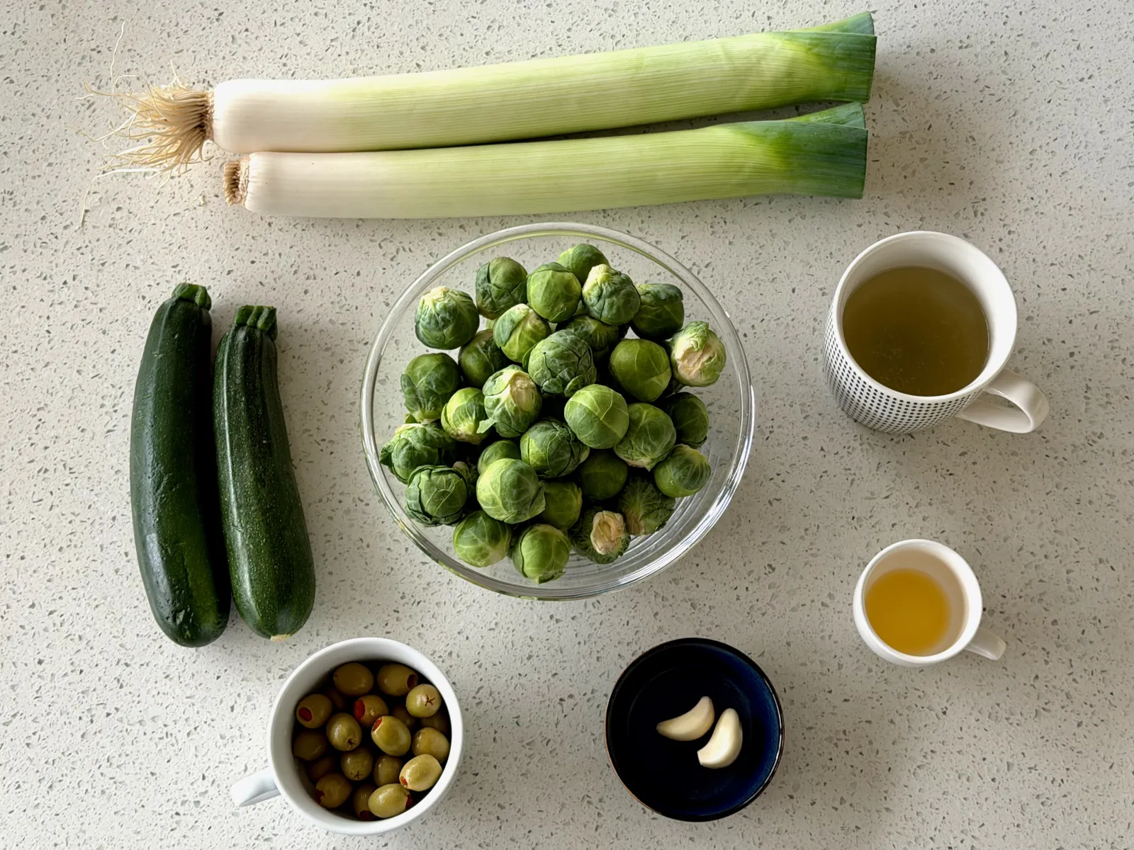 Brussels sprouts, leeks, zucchini, olives and garlic: ingredients for Brussels sprouts recipe