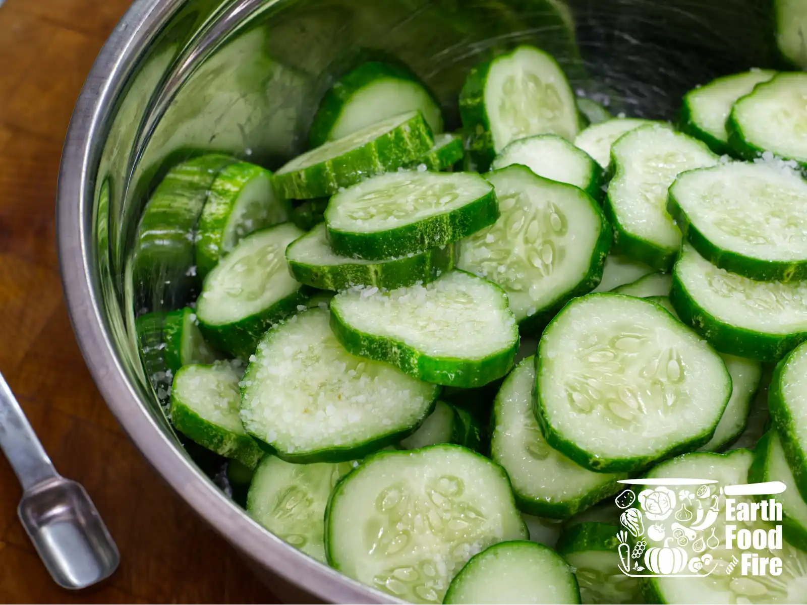 Pickling salt mixed into the sliced cucumbers before their fridge rest.