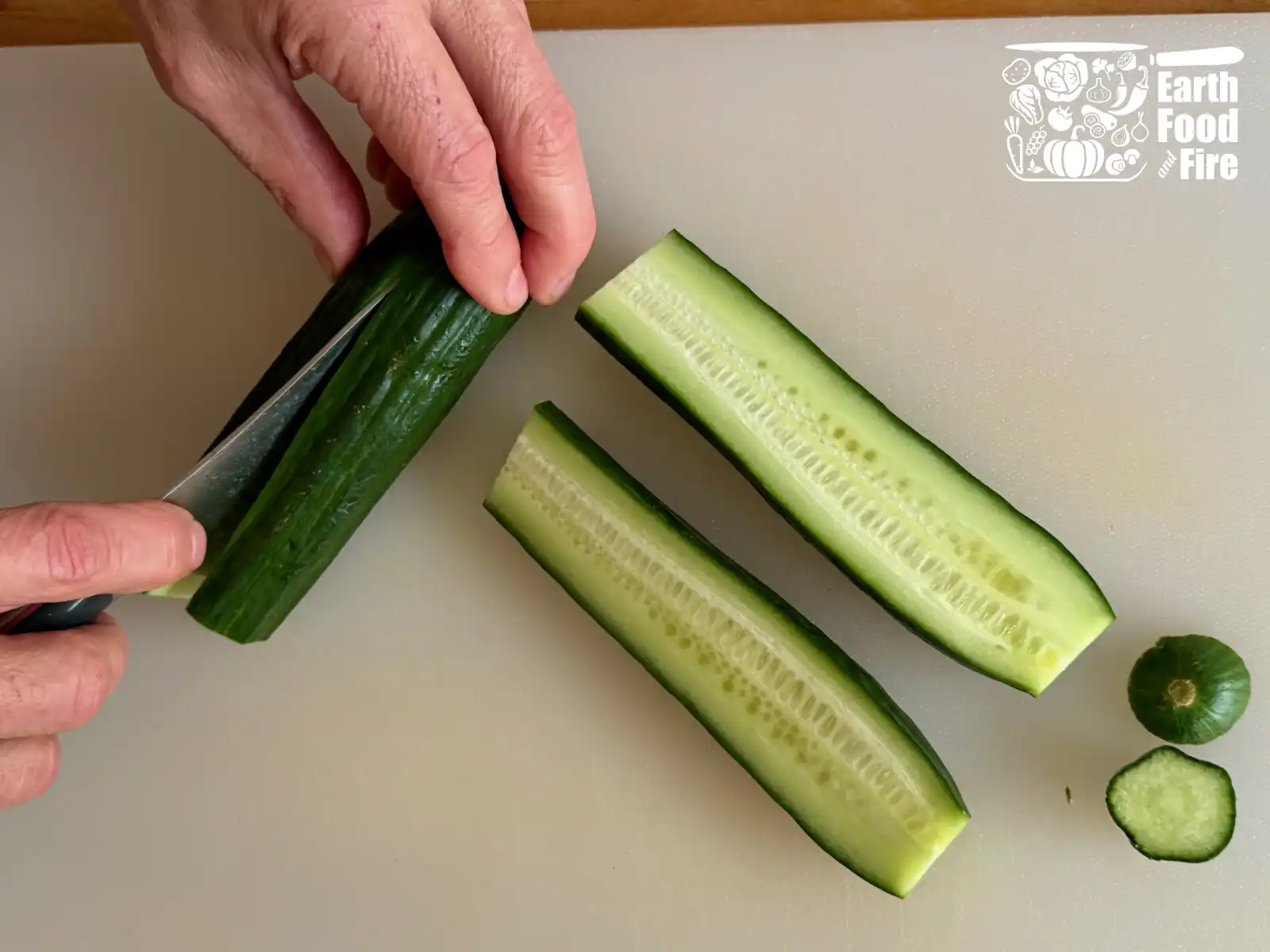 Slicing cucumbers in half