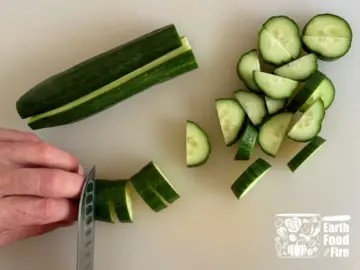 Slicing cucumber into half-moons for a feta cheese and watermelon salad recipe